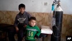 Children who have inhaled sulfur fumes wait for treatment at a hospital in Qayyarah, about 31 miles (50 km) south of Mosul, Iraq, Oct. 23, 2016.