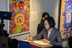 Taiwan’s President Tsai Ing-wen signs the guest book during her visit to the Musée de Panthéon Nationale, in Port au Prince, Haiti, July 13, 2019. (@jovenelmoise Twitter)