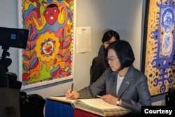 Taiwan’s President Tsai Ing-wen signs the guest book during her visit to the Musée de Panthéon Nationale, in Port au Prince, Haiti, July 13, 2019. (@jovenelmoise Twitter)