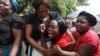 FILE: A family member of Kelvin Tinashe Choto reacts, during his funeral in Chitungwiza, about 30 kilometres south east of the capital, Harare, Zimbabwe, Saturday, Jan, 19, 2019.
