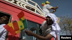 FILE —A supporter of Senegal's president Macky Sall shows his support of the president after the postponement of the February 25 presidential election and ahead of a national dialogue proposed by Sall, in Dakar, Senegal February 24, 2024.