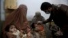 A healthcare worker administers a polio vaccine to a child at a clinic, in Peshawar, Pakistan, Tuesday, Dec. 1, 2020. 