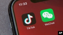 Icons for the smartphone apps TikTok and WeChat are seen on a smartphone screen in Beijing, Friday, Aug. 7, 2020. 