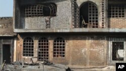 View of homes and a car torched in the explosion of an oil pipeline in Texmelucan, Puebla State, 19 Dec 2010