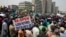 Anti-government protesters hold flags as they march in Abuja, Nigeria, Feb. 9, 2017. 
