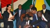 South Sudan President Salva Kiir, seated, signs a peace deal as Kenya’s President Uhuru Kenyatta, center-left, Ethiopia’s Prime Minister Hailemariam Desalegn, center-right, and Uganda’s President Yoweri Museveni, right, look on in Juba, South Sudan, Aug. 26, 2015. Rebel leader Riek Machar signed the deal nine days earlier. 