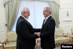 Iranian President Masoud Pezeshkian meets with top Hamas leader Ismail Haniyeh in Tehran, July 30, 2024. Hamas said that Israel a day later assassinated Haniyeh in Tehran, where he had traveled to attend the swearing-in of Iran’s new president.