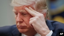 President Donald Trump listens during a meeting on healthcare in the Roosevelt Room of the White House in Washington, Monday, March 13, 2017.