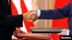  U.S. President Barack Obama and Russian President Dmitry Medvedev shake hands as they exchange the signed new Strategic Arms Reduction Treaty (START II) at Prague Castle in Prague, April 8, 2010.