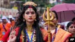 A woman dressed as Hindu goddess Durga participates in a procession to celebrate the recognition of Durga Puja by UNESCO, in Kolkata, India, Thursday, Sept. 1, 2022. '