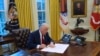 FILE - US President Donald Trump signs executive orders in the Oval Office at the White House, Jan. 30, 2025, in Washington.