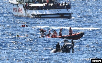 migrants leave spanish charity ship migrants leave spanish charity ship