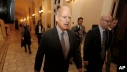 FILE - California Gov. Jerry Brown returns to his office after a meeting in Sacramento, California, April 6, 2017. Brown and the California Legislature are among this year’s winners of the Jefferson Muzzles, satiric awards bestowed by a free speech group for what it considers egregious offenses.