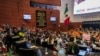 Protesters break into a Senate session in which lawmakers were debating the government's proposed judicial overhaul, which would make judges stand for election, in Mexico City, Sept. 10, 2024. The plan passed early Sept. 11 and now must be ratified by state legislatures.