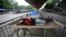 Homeless men sleep on a handcart parked on a road divider in a containment zone during lockdown in Bengaluru, India, July 5, 2020. 