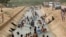 FILE - People cool themselves off in a canal as temperature reached 44 C (111 F) in Karachi, Pakistan, May 30, 2018. 