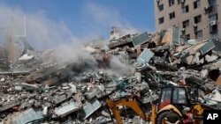 Зруйнована ізраїльськими військами будівля, де знаходились офіси The Associated Press, Al-Jazeera та інших ЗМІ у Смузі Газа. 16 травня 2021 