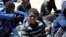 FILE - Migrants who attempted to flee to Europe wait in Libyan coast guard detention in the coastal city of Tripoli, Libya, May 16, 2016. 