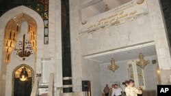 Security personnel inspect the site of a bomb attack inside the Umm al-Qura mosque in Baghdad, August 28, 2011