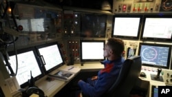 A French navy worker looks at screens in the navigation and operations center in the new French nuclear-powered submarine "Suffren" in Cherbourg, north-western France, July 12, 2019. 