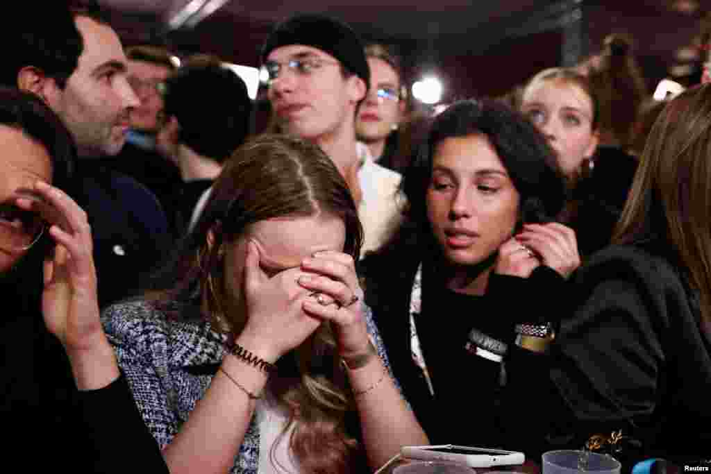 Social Democratic Party (SPD) supporters react after the first exit poll results are announced in the 2025 general election, in Berlin, Germany.