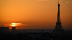 TOPSHOT - This photograph taken on November 4, 2024 shows the sun setting as the silhouetted Eiffel Tower dominates the Paris skyline. (Photo by Christophe DELATTRE / AFP)