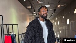 FILE - Adeju Thompson wears one of his designs made for winter, inspired by the traditional Egungun masquerade, at Alara store in Lagos, Nigeria, February 20, 2024.