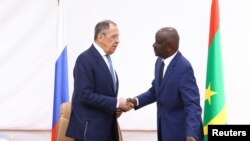 FILE: Russia's Foreign Minister Sergei Lavrov and Mauritania's Foreign Minister Mohamed Salem Ould Merzoug shake hands during a news conference following their talks in Nouakchott, Mauritania, February 8, 2023. Russian Foreign Ministry/Handout via REUTERS 