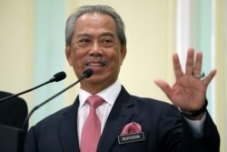 Malaysia's Prime Minister Muhyiddin Yassin speaks during a news conference in Putrajaya, March 11, 2020.