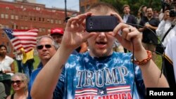 A supporter of Republican presidential candidate Donald Trump takes a picture at a pro-Trump rally near the Republican National Convention in Cleveland, Ohio. (Reuters)