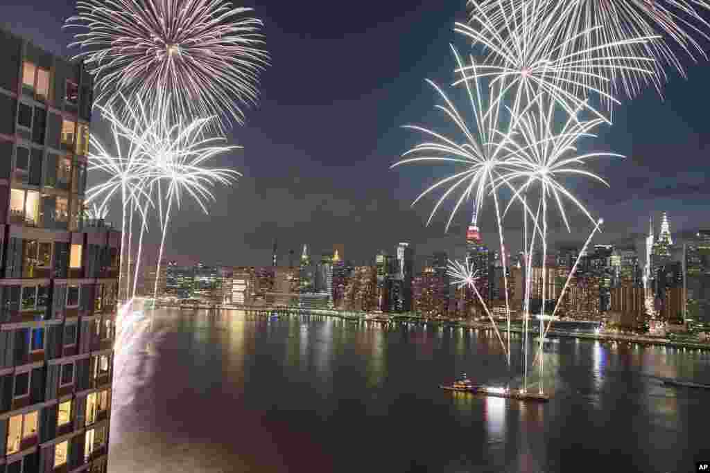 With the New York City skyline in the background fireworks explode during an Independence Day show over the East River, July 4, 2017.