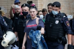 Police detain RT television channel journalist Maria Sherstyukova during a rally to support Ivan Safronov near the Lefortovo prison in Moscow, Russia, July 13, 2020. Safronov, a former military journalist, was arrested and charged with treason.