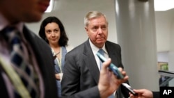 FILE -Sen. Lindsey Graham, R-S.C. is followed by reporters on Capitol Hill in Washington, May 23, 2017. 