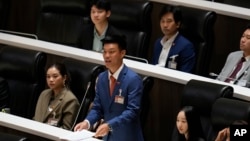 FILE - Leader of People's Party, Natthaphong Ruengpanyawut asks a question after Thailand's Prime Minister Paetongtarn Shinawatra makes the policy statement at parliament in Bangkok, Sept. 12, 2024. 