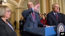 Sen. Chuck Schumer, D-N.Y., joined by Sen. Patty Murray, D-Wash., left, and Senate Minority Leader Harry Reid, D-Nev., right, criticizes Republicans for not doing enough to stop gun violence, during a news conference on Capitol Hill in Washington, Dec. 8, 2015.