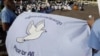 Cambodian students hold a peace banner as they celebrate the World Peace Day, in Phnom Penh, Cambodia, Friday, Sept. 21, 2012. More then one hundred of Cambodians from three religions, Buddhism, Christianity, and Islam, gathered together on Friday. (AP Photo/Heng Sinith)