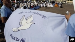 Cambodian students hold a peace banner as they celebrate the World Peace Day, in Phnom Penh, Cambodia, Friday, Sept. 21, 2012. More then one hundred of Cambodians from three religions, Buddhism, Christianity, and Islam, gathered together on Friday. (AP Photo/Heng Sinith)