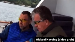 A screen grab of billionaire Oleg Deripaska (left) and Russian Deputy Prime Minister Sergei Prikhodko (R) allegedly on board the business tycoon's yacht. 