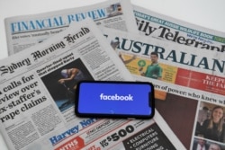 An illustration image shows a phone screen with the "Facebook" logo and Australian newspapers in Canberra, Australia, Feb. 18, 2021.