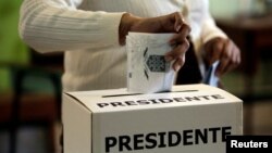 A voter casts his ballot during the presidential election at a polling station in San Jose, Costa Rica, Feb. 4, 2018. 