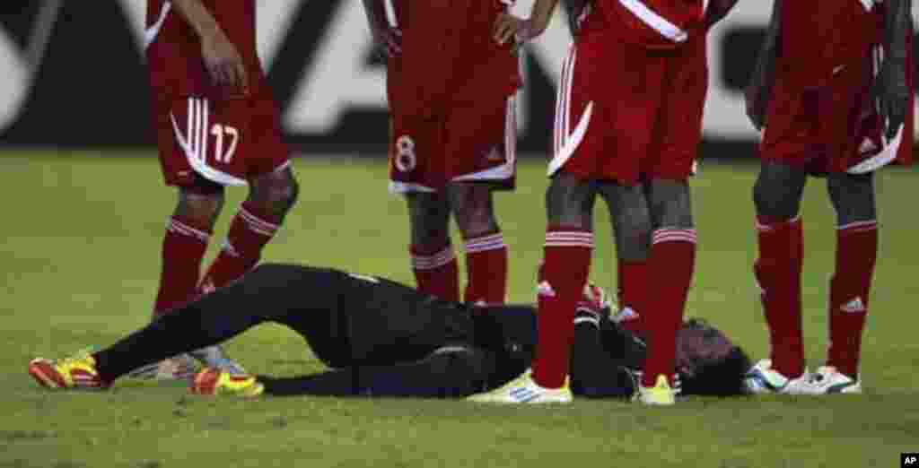 Sudan's goalkeeper Akram El Hadi Salim lies on the ground after sustaining an injuring during their African Nations Cup Group B soccer match against Burkina Faso at Estadio de Bata "Bata Stadium", in Bata January 30, 2012.