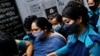 Bangladeshi journalist Rozina Islam, center, is escorted by police to a court in Dhaka, Bangladesh, May 18, 2021. 