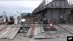 Workers are seen near cable trench pit for the water intake of No.2 reactor at Tokyo Electric Power (TEPCO) Co.'s Fukushima Daiichi Nuclear Power Station in Fukushima prefecture in this handout photo released by TEPCO on May 17, 2011