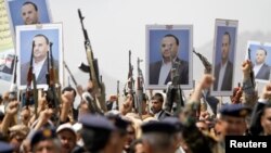 Houthi supporters hold posters of Saleh al-Samad, a senior Houthi official, during a funeral procession held for him and six others killed by Saudi-led airstrikes last week, in Sanaa, Yemen, April 28, 2018. 