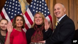 House Speaker Nancy Pelosi of Calif., right, poses during a ceremonial swearing-in with Rep. Pete Stauber, R-Minn., on Capitol Hill in Washington, Jan. 3, 2019, during the opening session of the 116th Congress.