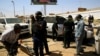 Security personnel stand near a car damaged after an explosion targeting the motorcade of Sudan's Prime Minister Abdalla Hamdok near the Kober Bridge in Khartoum, Sudan, March 9, 2020. 