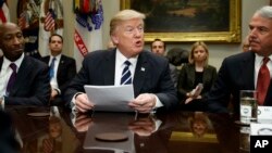 President Donald Trump, flanked by Merck CEO Kenneth Frazier, left, and Celgene CEO Robert Hugin speaks during a meeting with pharmaceutical industry leaders in the Roosevelt Room of the White House in Washington, Jan. 31, 2017.