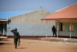 Nigerian soldiers walk inside the Government Science where gunmen abducted students in Kankara, in northwestern Katsina state, Nigeria, Dec. 15, 2020.