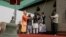 An old bell that was removed is seen in foreground as people from various faiths including Muslims, Hindus and Sikhs ring the new bell during its installation at the Holy Family Catholic Church in Srinagar, Indian controlled Kashmir, Oct. 29, 2017.