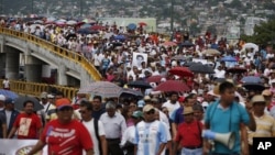 Demonstrators protest the disappearance of 43 students from the Isidro Burgos rural teachers college in Acapulco, Guerrero state, Mexico, Oct. 17, 2014. 